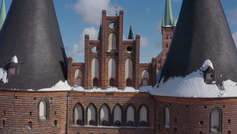 aerial view of the holsten gate in lübeck after snowing