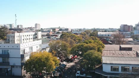 a push up drone shot of crowded city road under sunny conditions