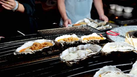 oysters being grilled by street vendors