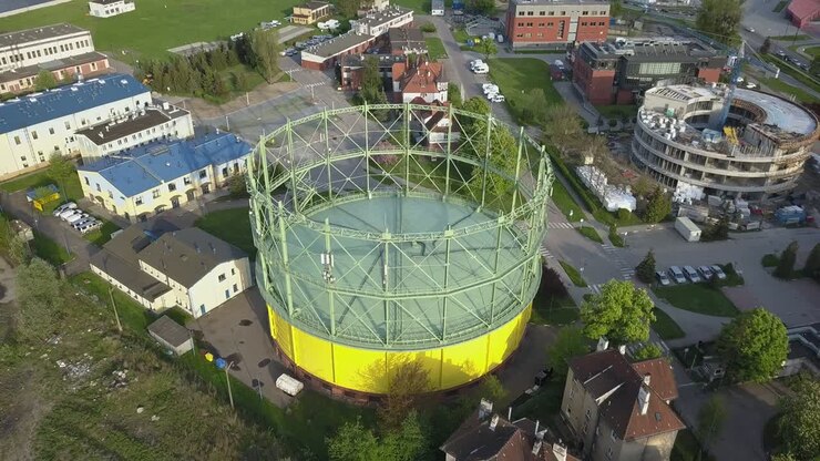 Aerial of Industrial City District and Round Gas Warehouse Building