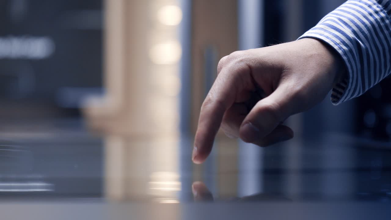 Close-up view about an interactive modern touch interface when a man using it.