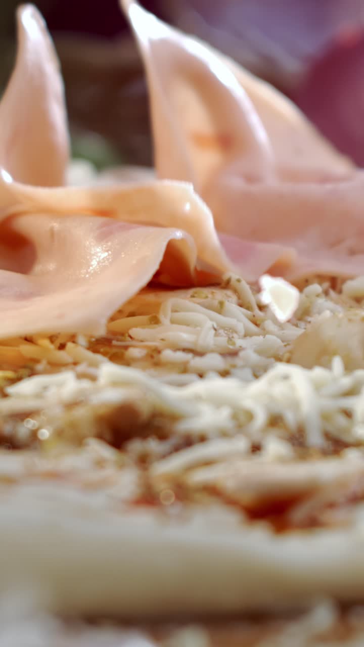 Preparing pizza with ham and cheese