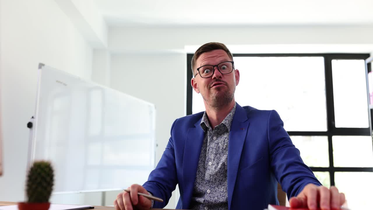 Frustrated Businessman Making Exaggerated Expressions in Office