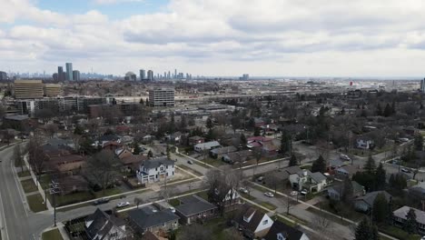 drone flying toward downtown suburban area near toronto in winter