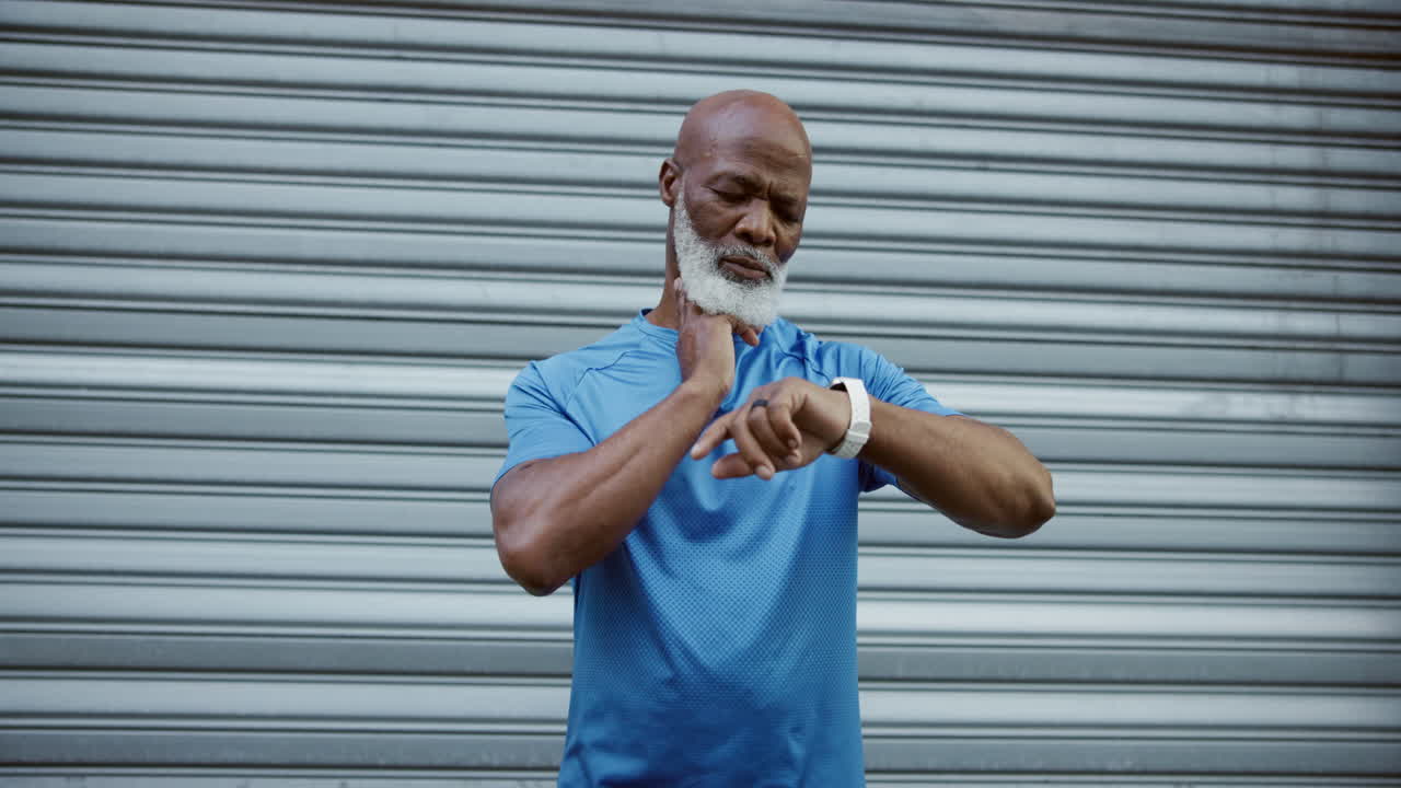 Senior man checking his pulse after workout