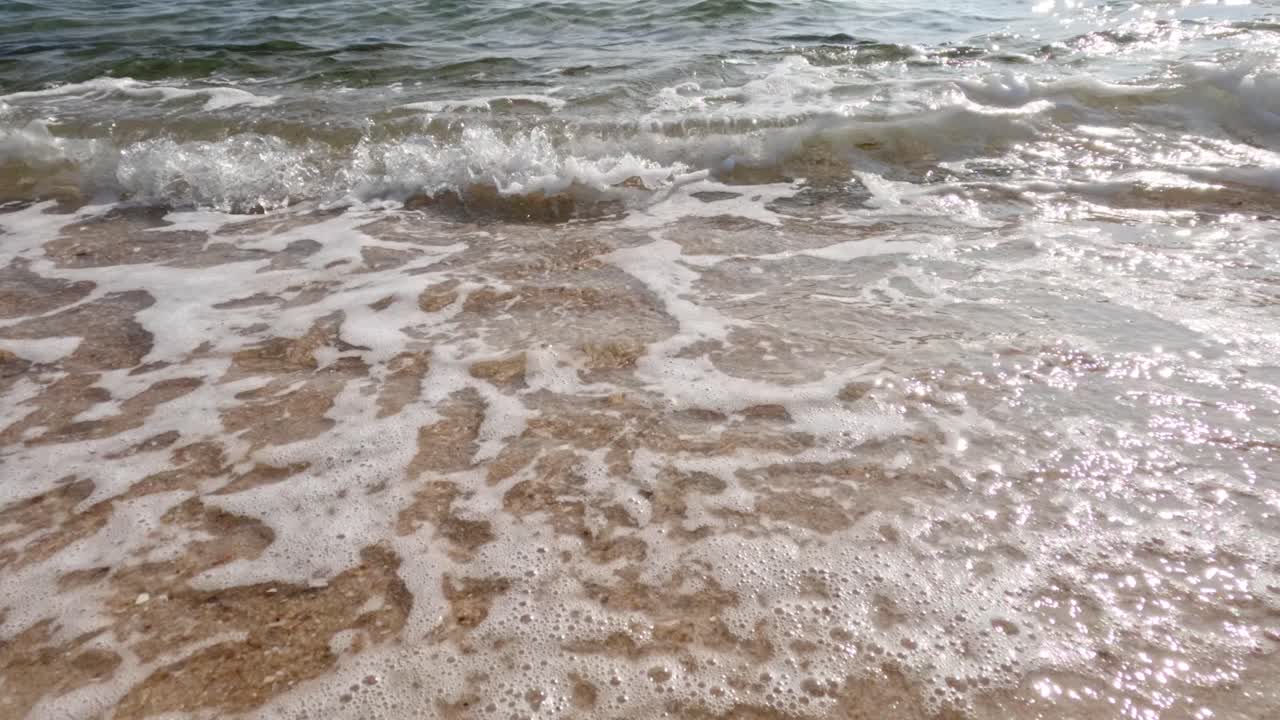 모래 해변에 부드럽게 부히는 파도