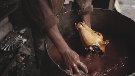 african man washing the meat