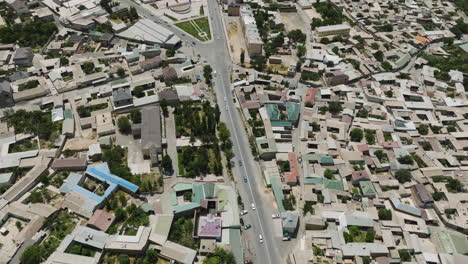 Aerial-View-Of-Istaravshan-City-With-Asphalt-Road-Between-Dense-Structures-In-Sughd-Province,-Tajikistan