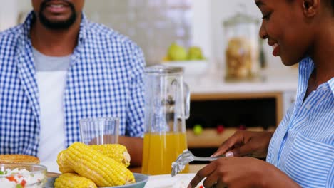 Couple-having-meal-on-dining-table-at-home