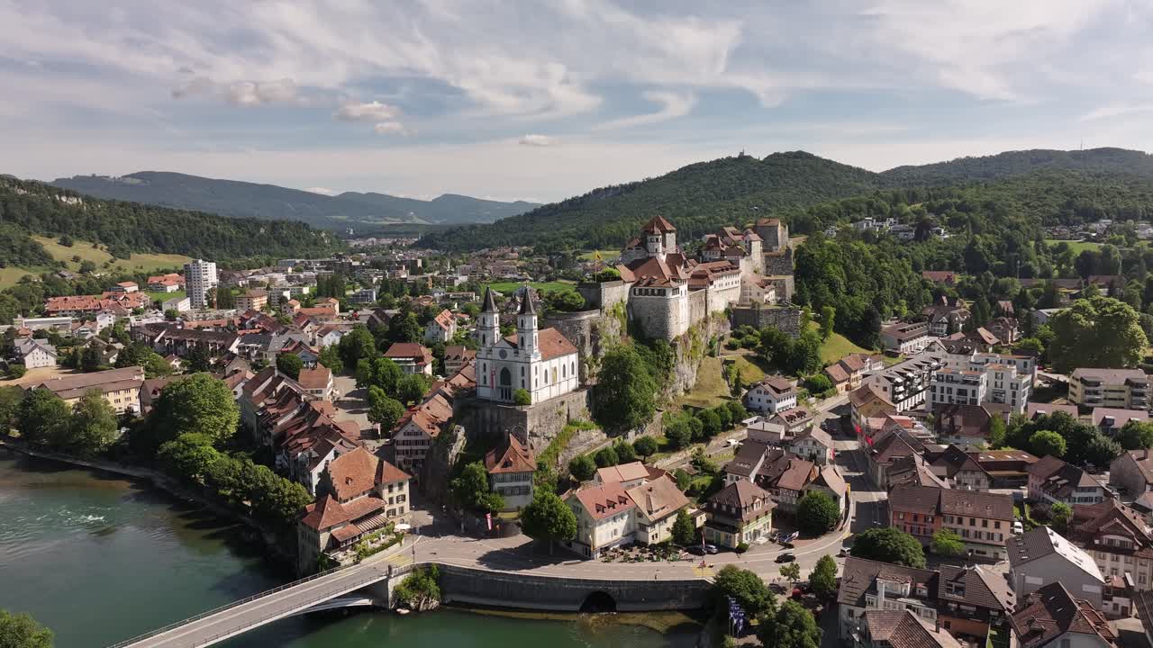 Aerial view of Aarburg castle, church, and town nestled in the hills along the Aare river in Switzerland