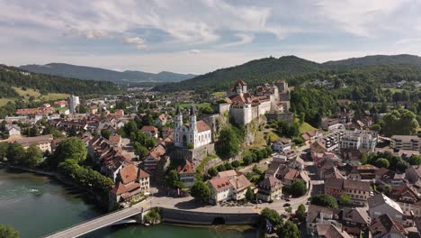 aerial view of aarburg castle, church, and town nestled in the hills along the aare river in switzerland