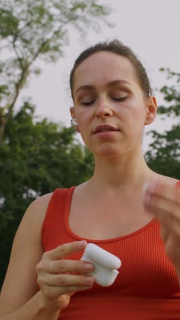 woman preparing for a workout in a park