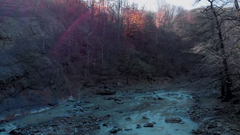 Aerial-drone-view-over-rapids-in-middle-of-foliage-forest,-on-a-sunny,-fall-day