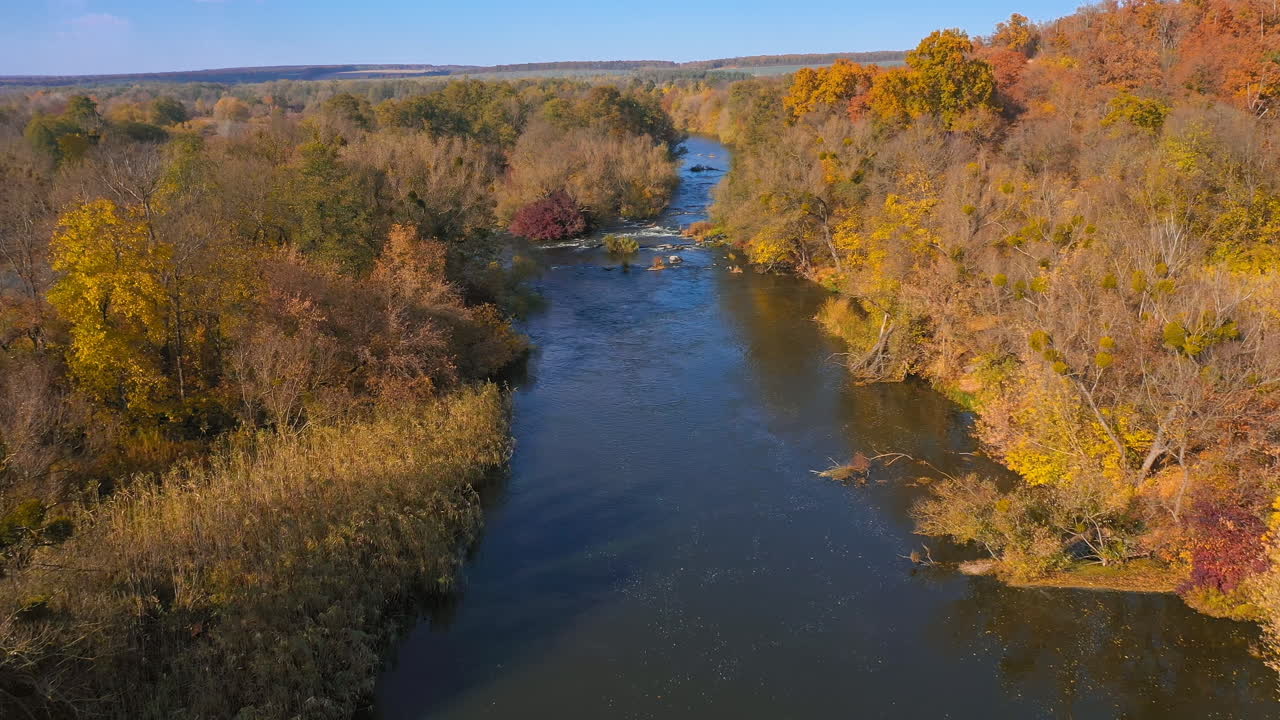 Scenery of beautiful autumn landscape. View from above of forest and autumn river