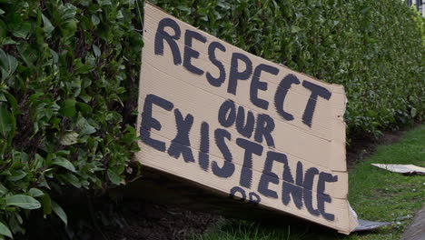 a cardboard protest sign left behind, at a march against global warming