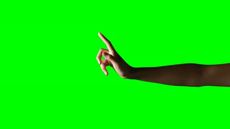 person making hand gesture against green screen background