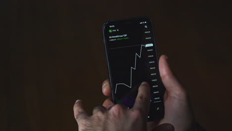 person viewing stock market data on smartphone