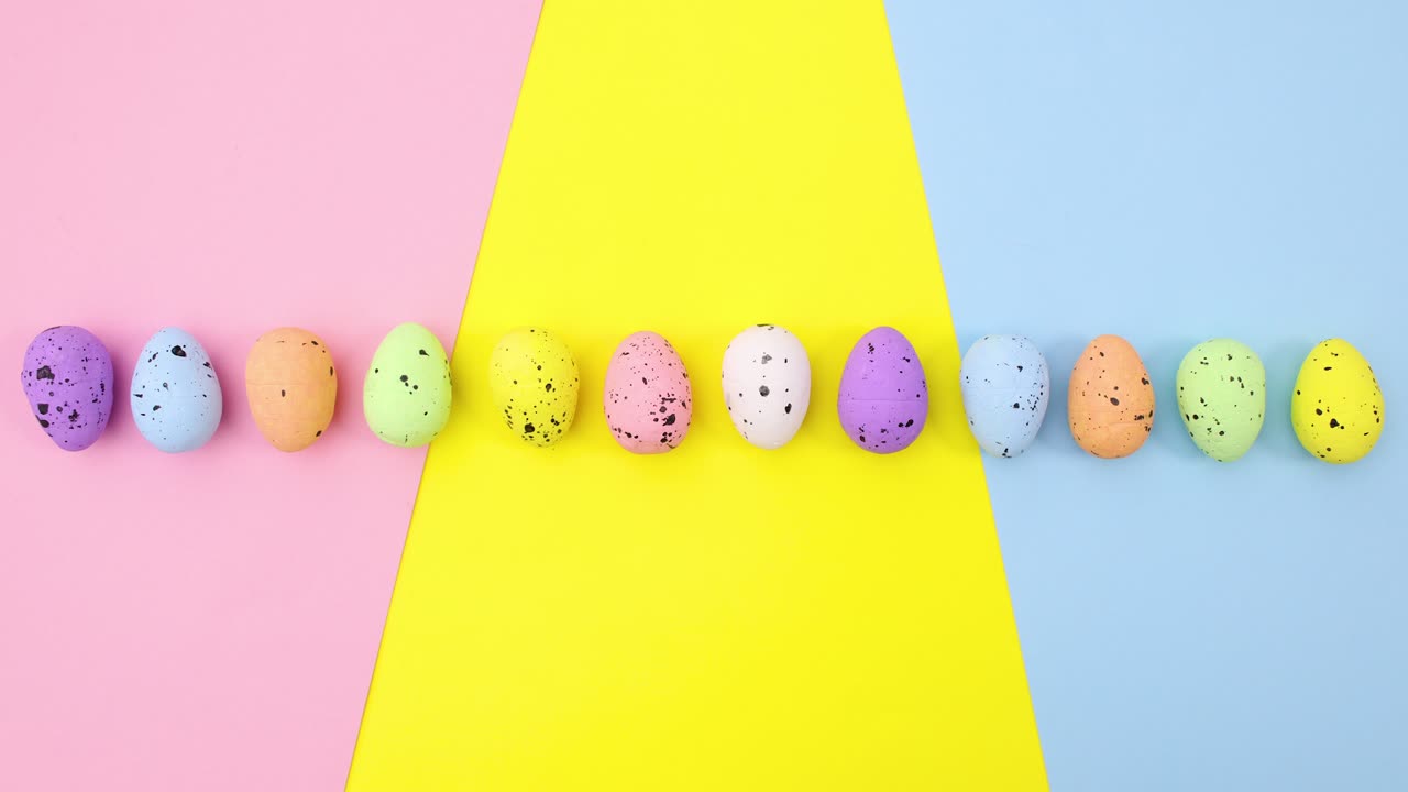 Easter eggs move one by one on pastel colorful theme. Stop motion