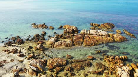 crystal clear azure ocean with sand dune and rocks