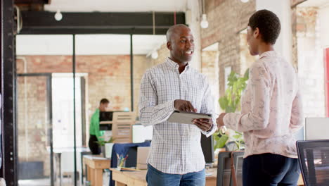 young african american business professionals discuss work in a bright office