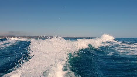 speedboat tail wave and water spray on sea surface