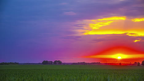 Colorful-sunset-over-farmland-countryside-crops---time-lapse