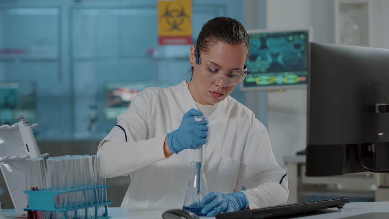 Scientist working with micro pipette for liquid in beaker and test tube