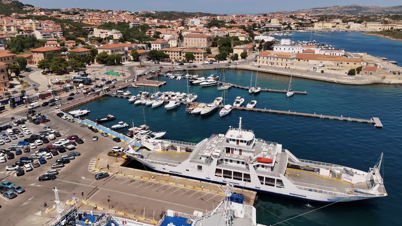 Aerial view of La Maddalena port with ferries and boats on a sunny day