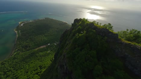 drone flying down the cliffs of le morne brabant in mauritius