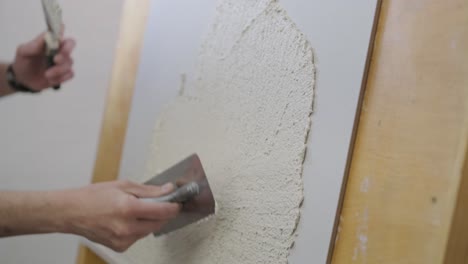 applying plaster to a wall