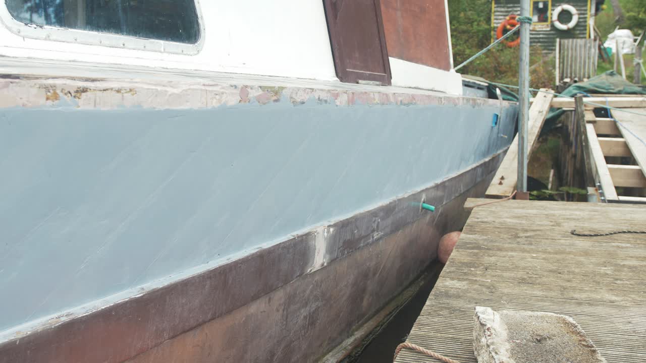 Old boat being renovated into liveaboard painted with grey primer