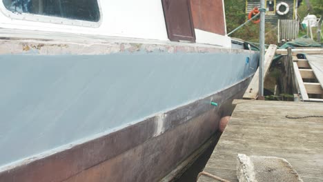 old boat being renovated into liveaboard painted with grey primer