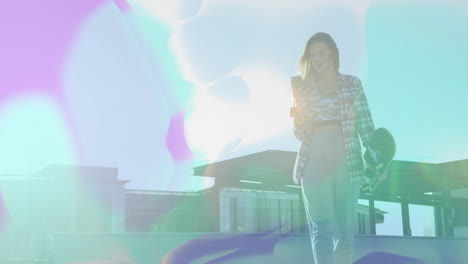 woman walking rooftop, carrying helmet and checking phone while showing animated tech chart icons