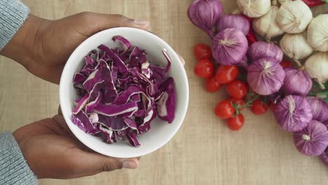 preparing red cabbage salad with other ingredients