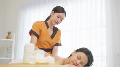 woman receiving a back massage at a spa