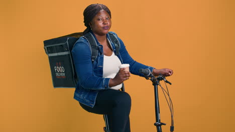 courier takes coffee break on bicycle