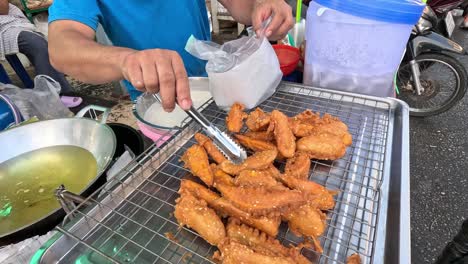 vendor frying and packaging bananas for sale