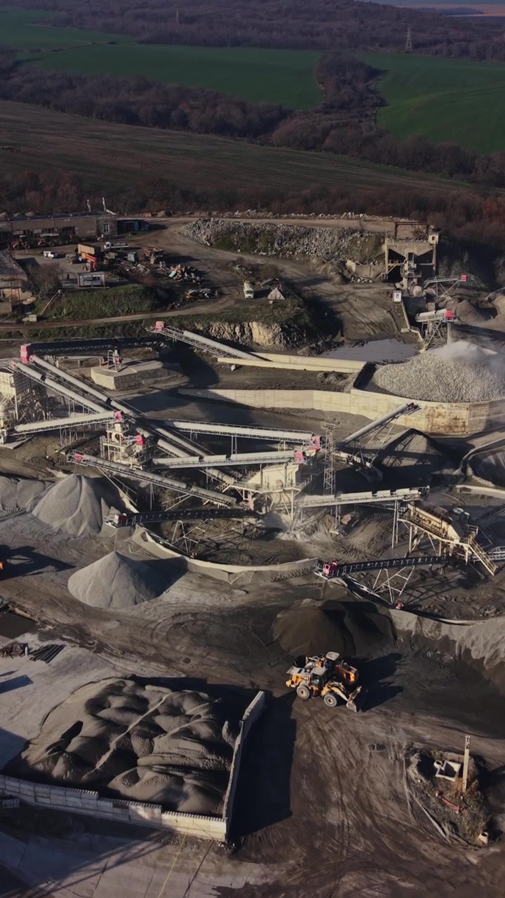 Mining activities at a quarry site in a rural area during daylight