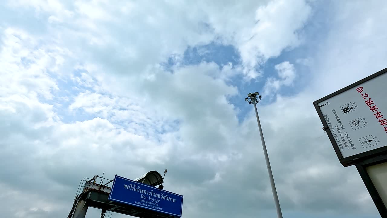 Cloudy day at Koh Samui ferry terminal with people boarding. Dynamic camera angles capture the bustling atmosphere and overcast sky