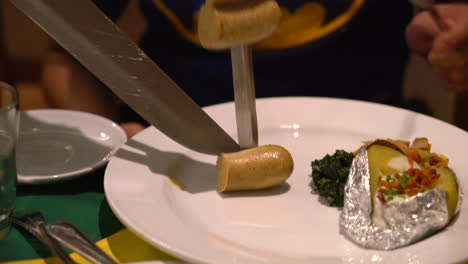 slicing steak brazillian style on plate