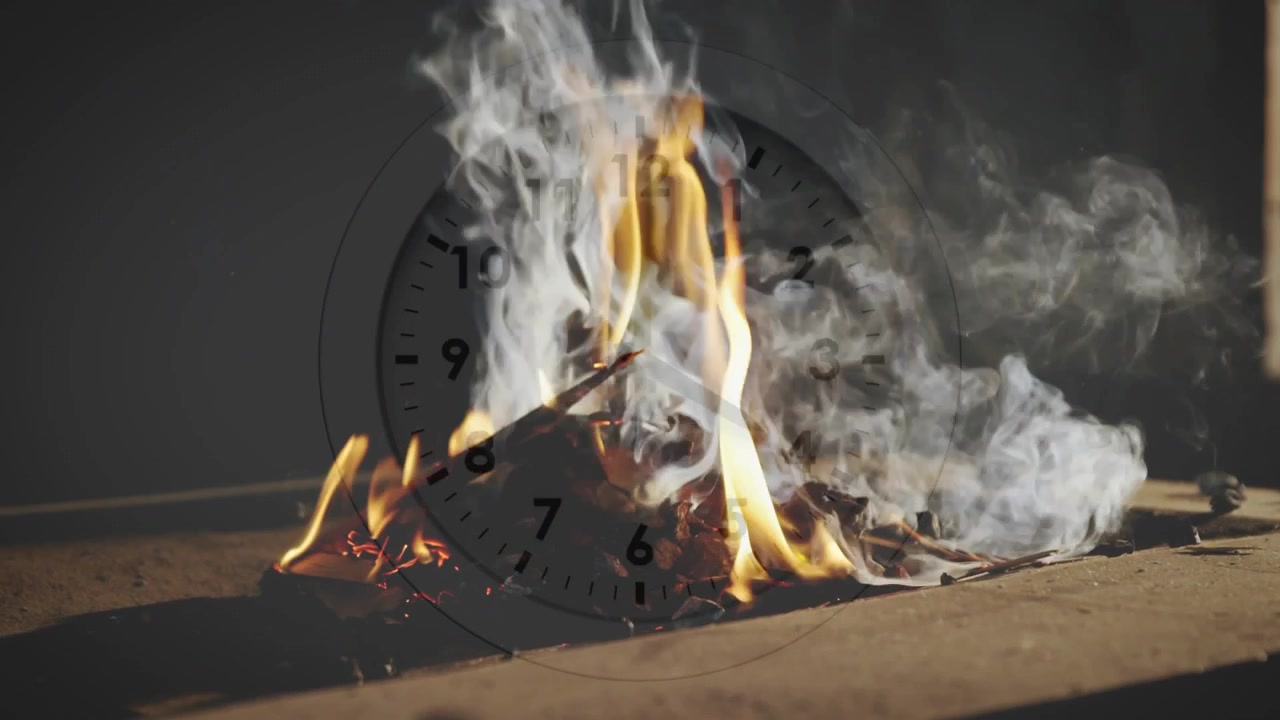 Glødende bunke brænder fra gnist, flammer vokser, røg vælter mod højre, ur viser tid.