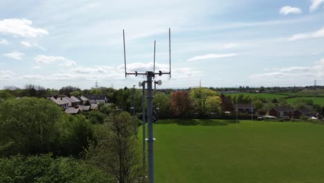 aerial view circling neighbourhood sports field telecommunication tower for digital signals