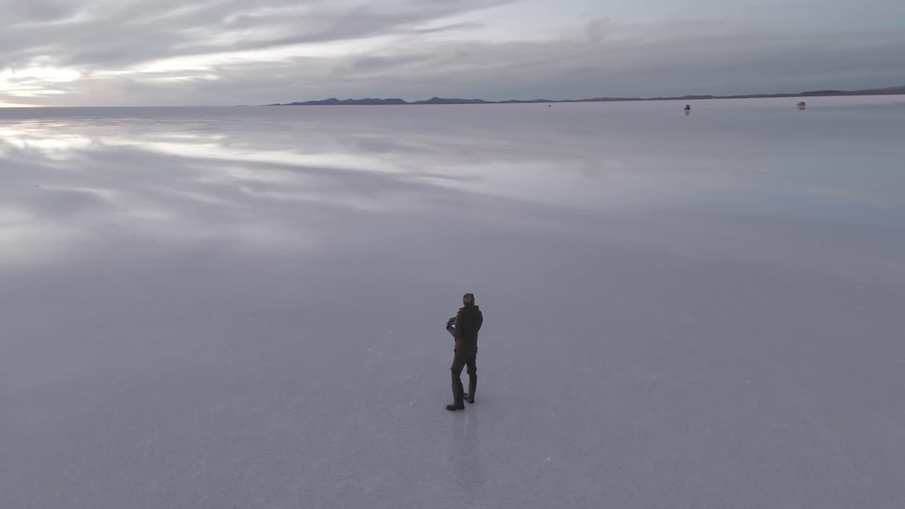 Drone Flies Toward Distant Horizon at Uyuni Sunset