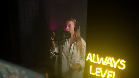 woman singing in a recording studio