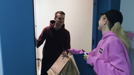 Delivery-woman-with-paper-bags-and-a-clipboard