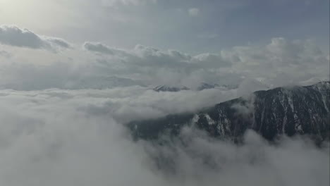 aerial drone view: cloud-shrouded mountain ridge