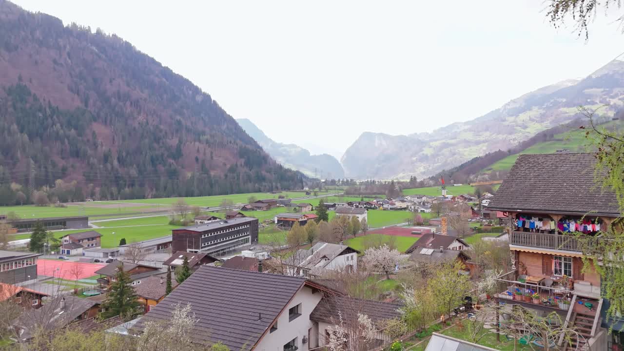 A village in schiers, switzerland, with green fields and mountains, aerial view
