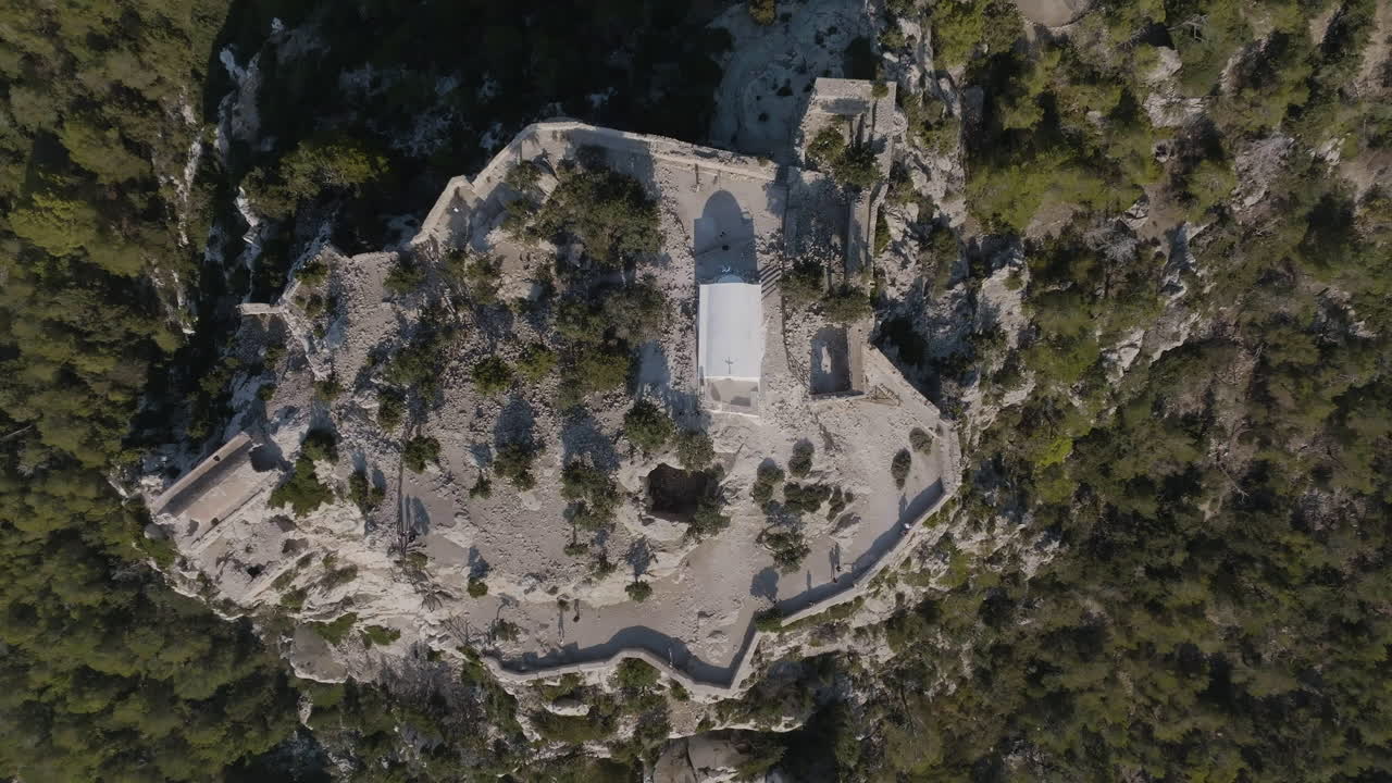 Cenital drone shot rising above the Castle of Monolithos, in sunny Rhodes, Greece