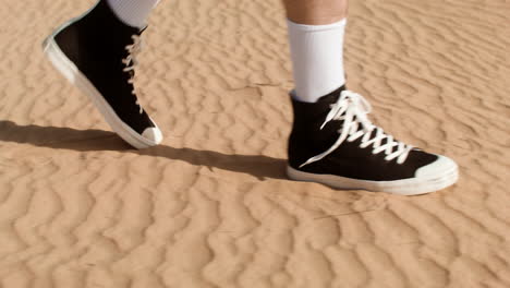 man with black sneakers walking