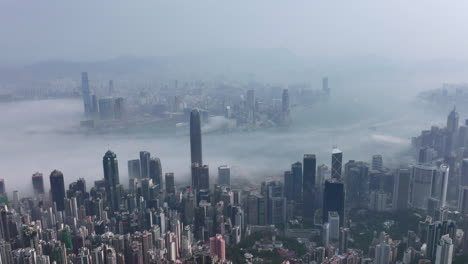 timelapse slow pulling away of fog covered hong kong city skyline and victoria harbour